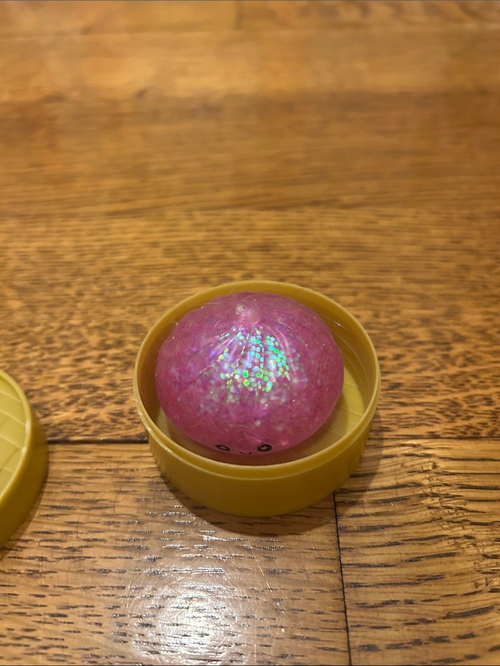 Mini purple glitter dumpling squishy.